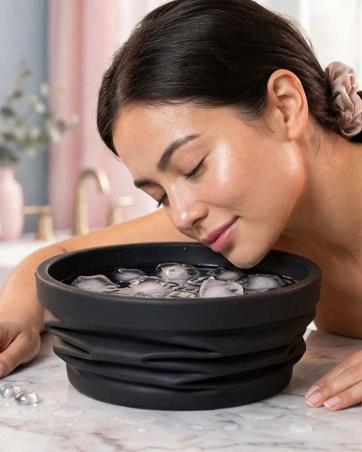 Woman dipping her face into the Frost Glow ice bowl